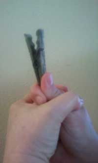left hand holding the right hand holding the clothes pin
